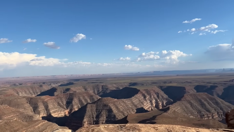 A Vast Desert Landscape with Layered Canyons and Distant Mountains in Monument Valley, Arizona