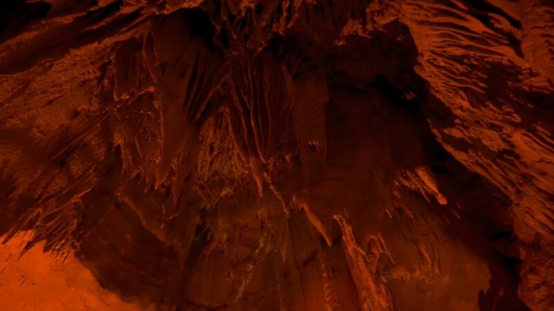 Dark interior of Mammoth Cave with dramatic rock formations and orange lighting