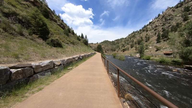 Paved trail along Clear Creek Canyon with river views and rocky hillsides