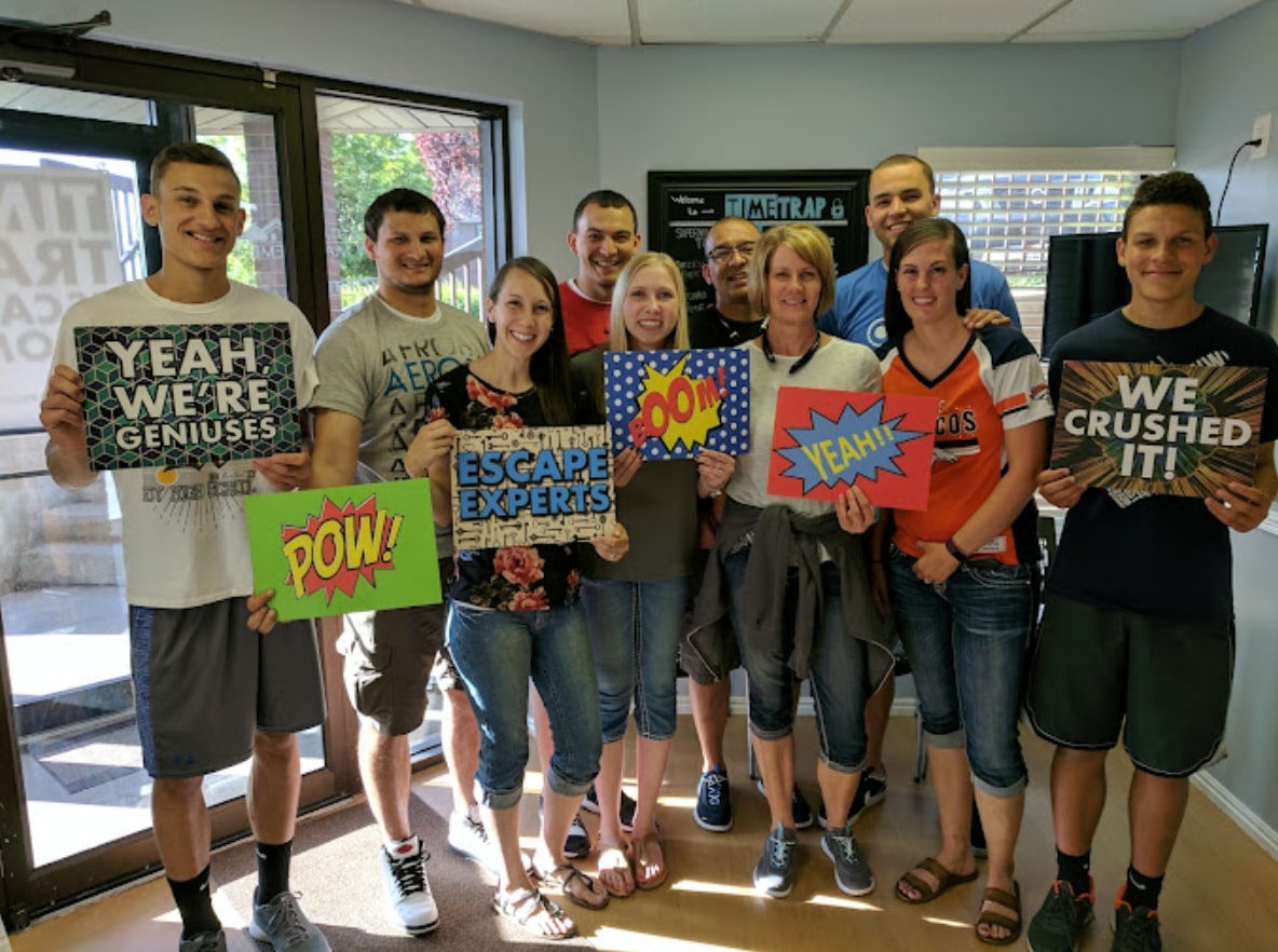 A group celebrating their escape room success at Time Trap Escape Rooms