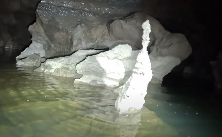 Water tumbles over rocks in a narrow canyon