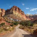 Scenic dirt road winding through colorful cliffs and rock formations in Capitol Reef National Park