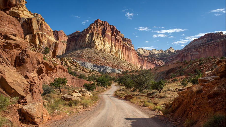 Scenic dirt road winding through colorful cliffs and rock formations in Capitol Reef National Park