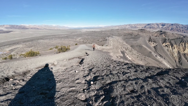 A hiker walks along the rim of Ubehebe Crater in Death Valley National Park