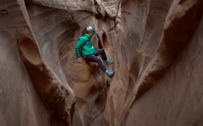 Hiker pauses in a narrow slot canyon