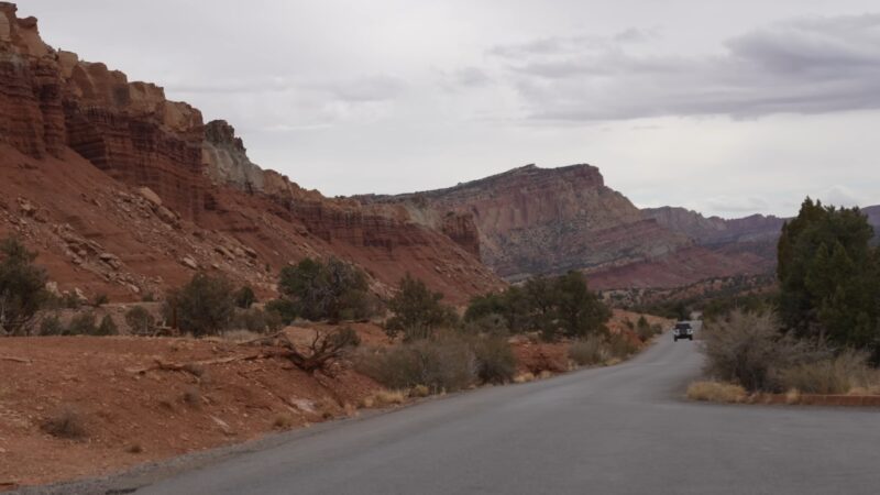 Road through red rock landscape on the Capitol Reef to Moab route toward Arches National Park