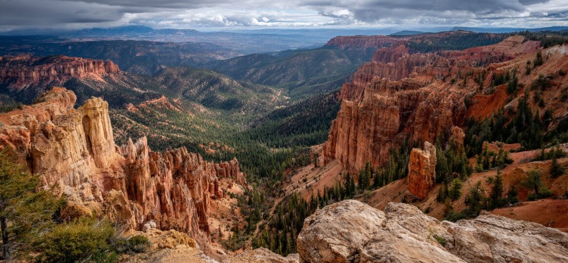 Panoramic view of Bryce Canyon with towering red rock hoodoos, forested valleys, and a cloudy sky